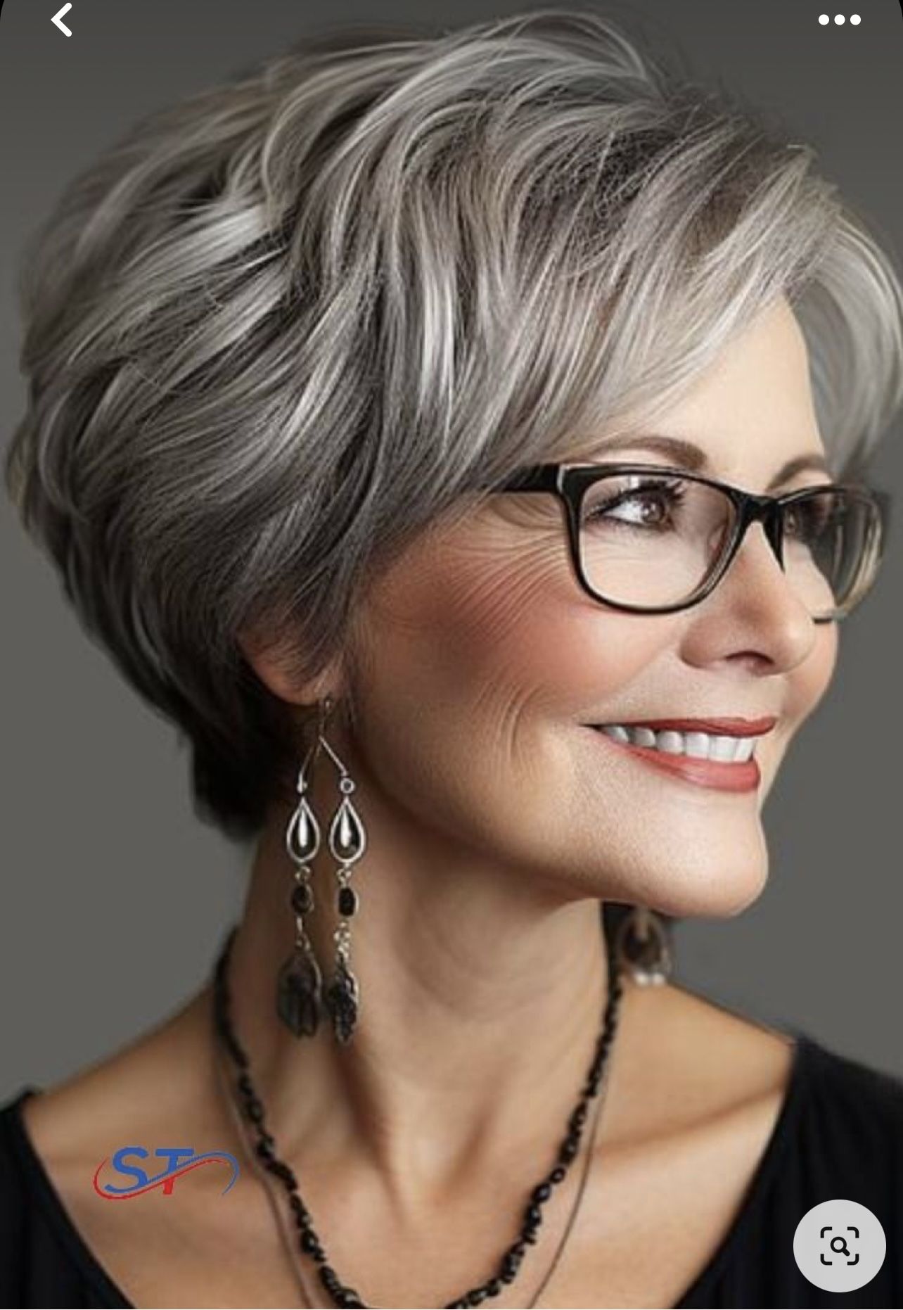 Femme de plus de 50 ans souriante avec une coupe pixie effilée et des lunettes tendance